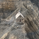 An aerial photo of a hiking lodge threatened by erosion.